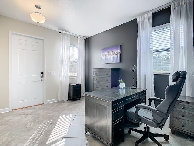 office space with a healthy amount of sunlight and light tile patterned flooring