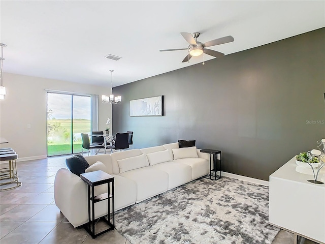 living room featuring ceiling fan with notable chandelier and tile patterned flooring