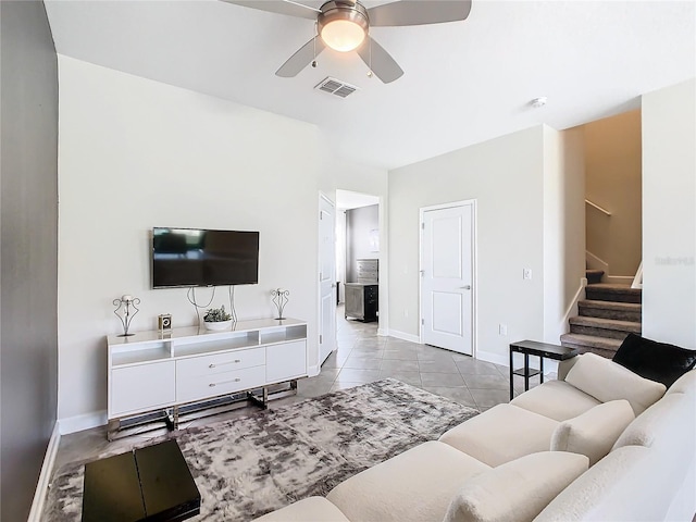 tiled living room with ceiling fan