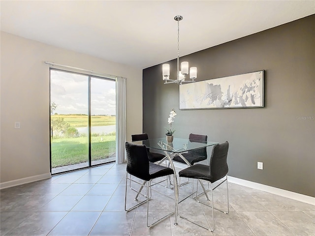 dining space featuring a notable chandelier and light tile patterned floors