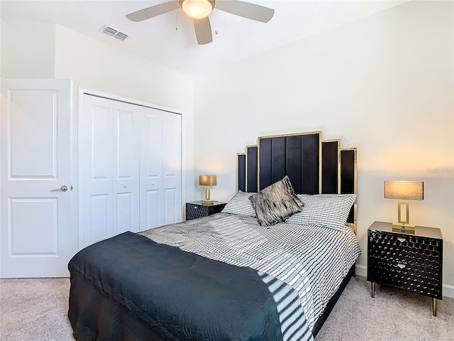 carpeted bedroom with a closet and ceiling fan