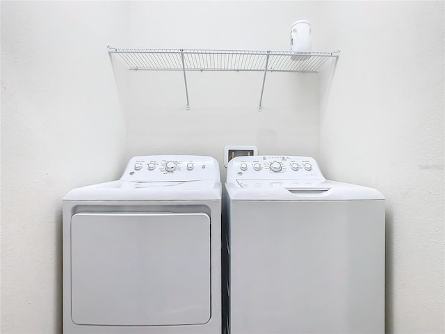 clothes washing area with washing machine and clothes dryer