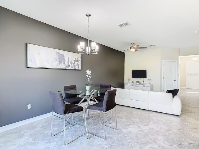 dining room with light tile patterned flooring and ceiling fan with notable chandelier