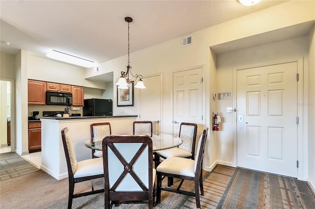 dining room with a notable chandelier and dark carpet