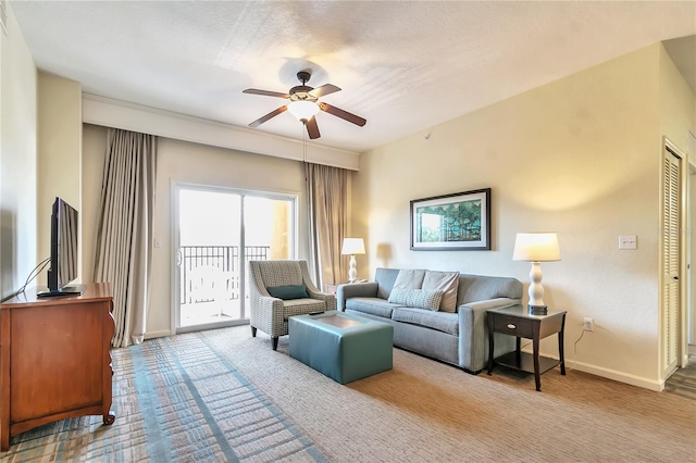 carpeted living room with a textured ceiling and ceiling fan