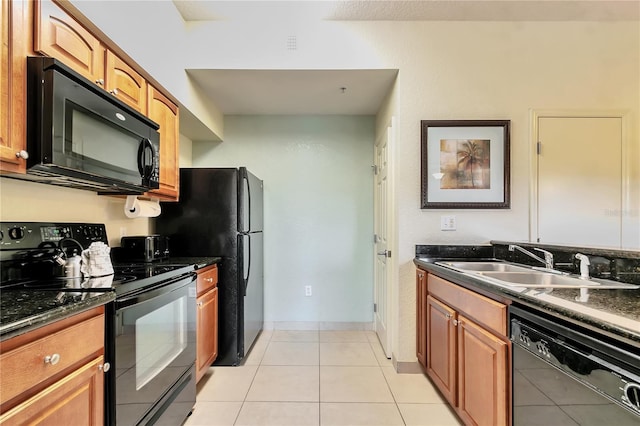 kitchen featuring black appliances, light tile patterned floors, sink, and dark stone counters