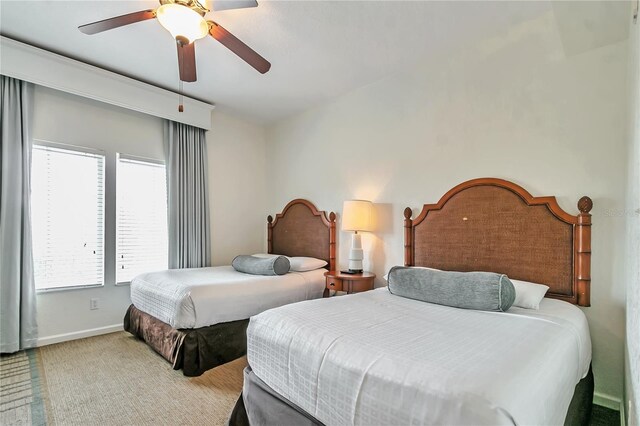 bedroom featuring ceiling fan and light carpet