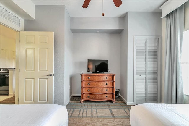 bedroom with ceiling fan and a closet