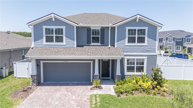 view of front of property featuring a garage and a front lawn