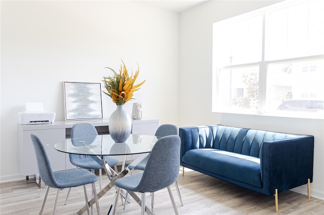 dining area featuring light hardwood / wood-style flooring and a healthy amount of sunlight