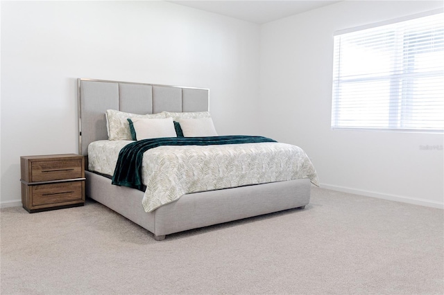 bedroom featuring light colored carpet