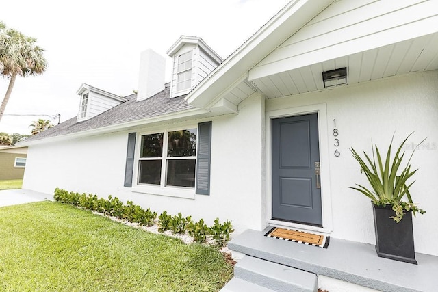 entrance to property with a yard