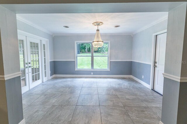 spare room with french doors, an inviting chandelier, and ornamental molding