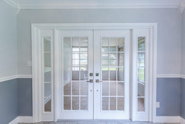 doorway to outside with ornamental molding and french doors