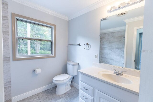 bathroom featuring vanity, toilet, and crown molding