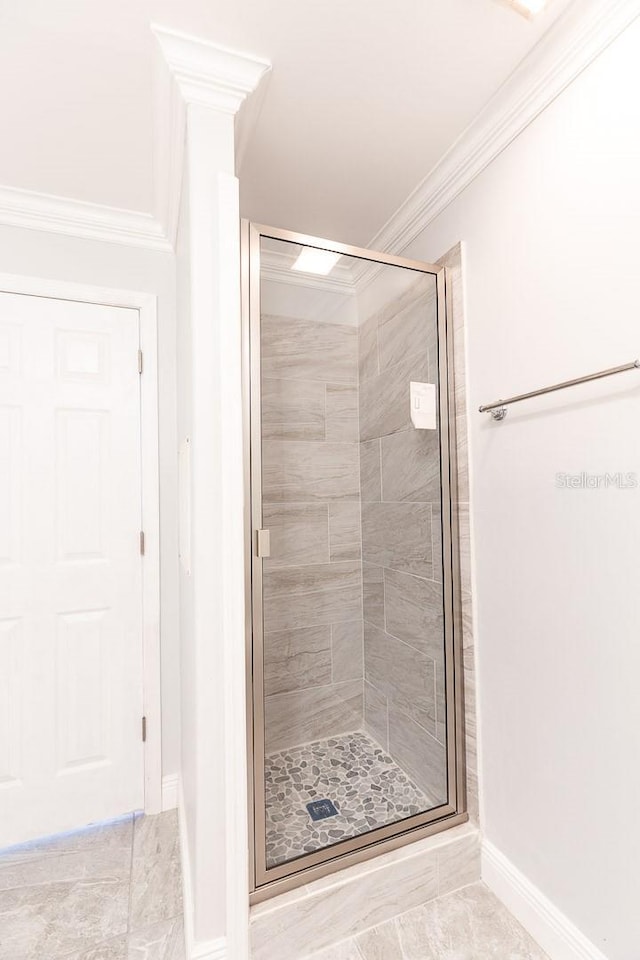 bathroom with crown molding and walk in shower