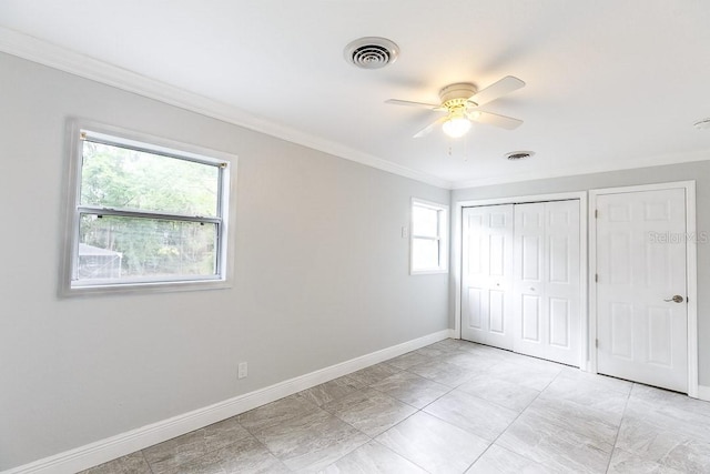 unfurnished bedroom with ceiling fan and ornamental molding