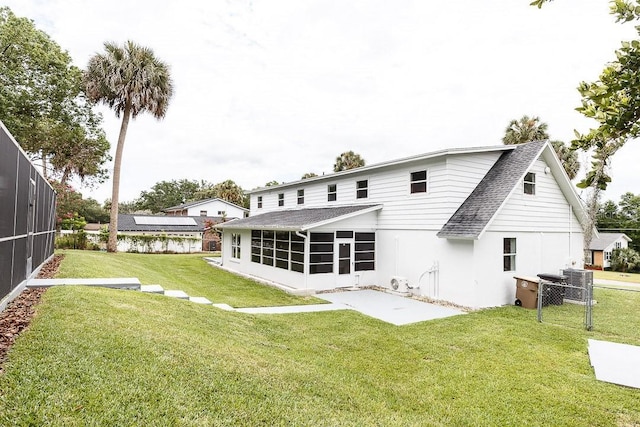 rear view of house with a sunroom and a yard