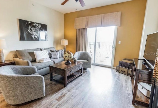 living room featuring wood finished floors and a ceiling fan