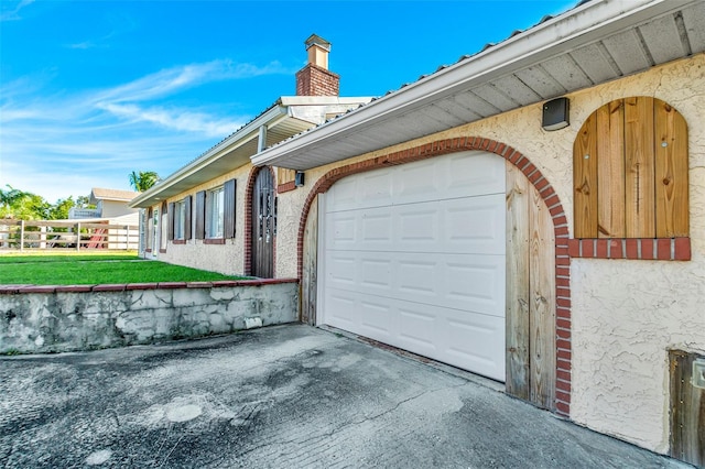 view of property exterior featuring a yard and a garage