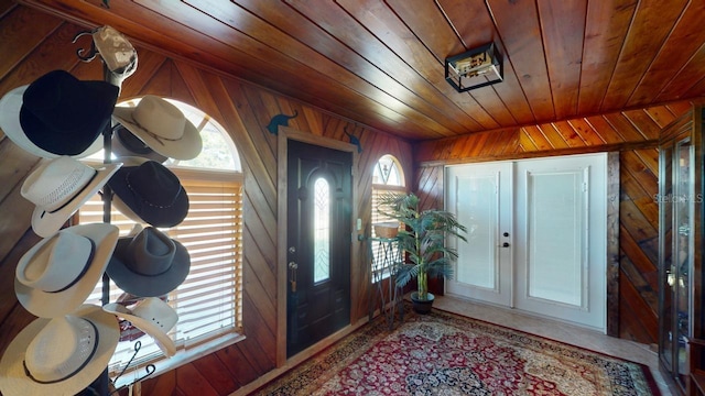 foyer with wooden walls and wooden ceiling