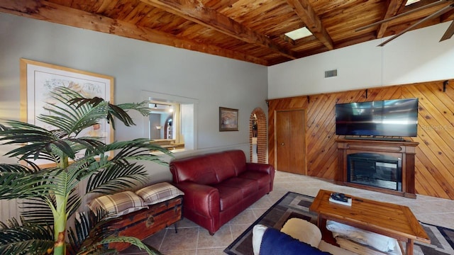 tiled living room featuring beamed ceiling, wood ceiling, and a high ceiling