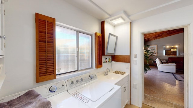 bathroom with washer and clothes dryer, vanity, and vaulted ceiling