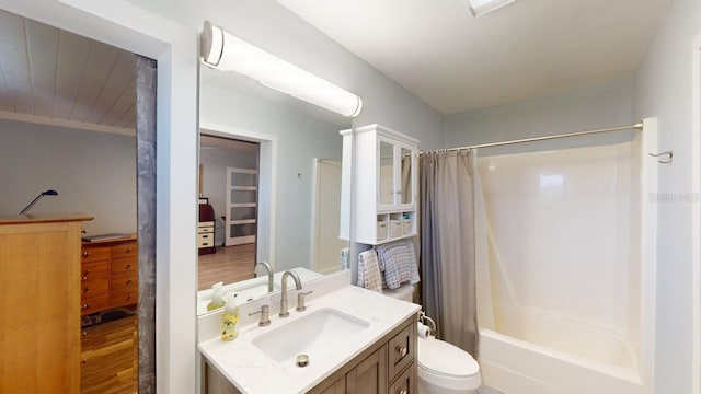 full bathroom with hardwood / wood-style floors, vanity, toilet, and shower / tub combo