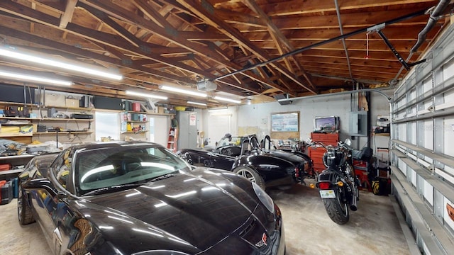 garage with electric panel and a garage door opener