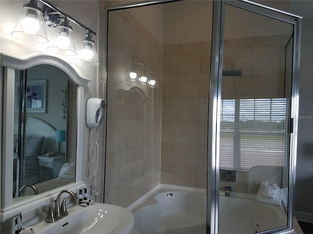 bathroom featuring tiled shower / bath combo and sink