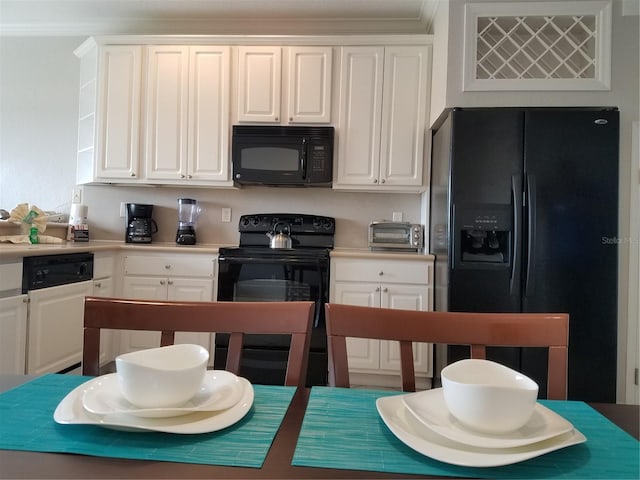 kitchen with white cabinetry, black appliances, and ornamental molding