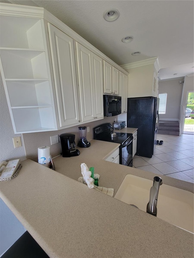 kitchen featuring kitchen peninsula, light tile patterned floors, ornamental molding, and black appliances