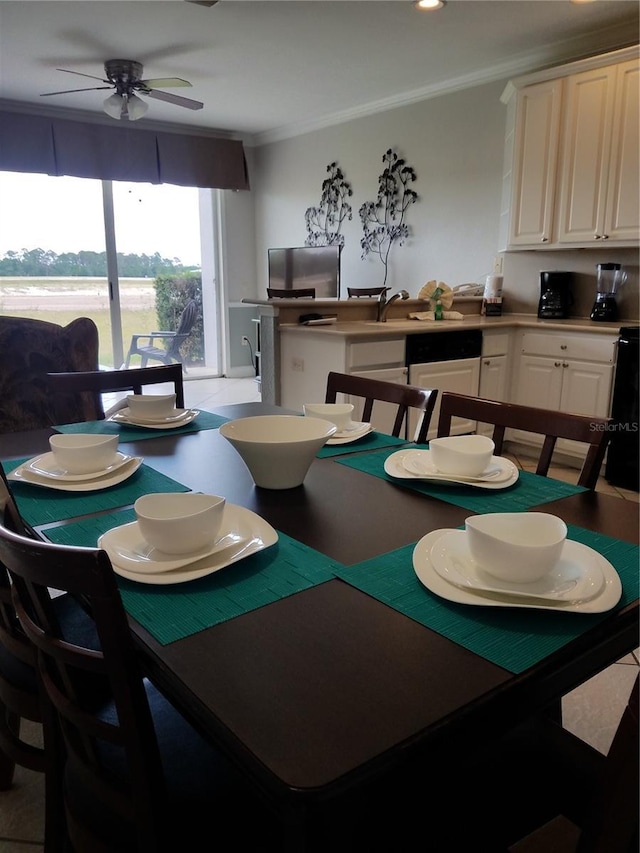 dining space featuring ceiling fan and ornamental molding