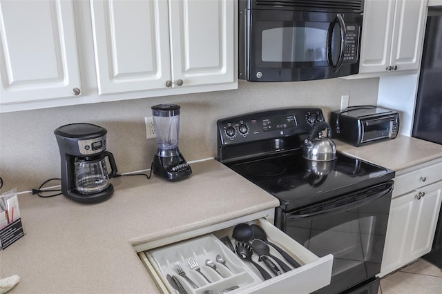 kitchen featuring white cabinetry and black appliances