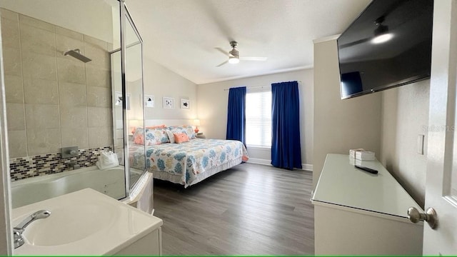 bedroom featuring ceiling fan, wood-type flooring, and vaulted ceiling