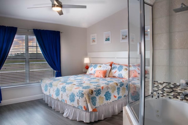 bedroom with ceiling fan, wood-type flooring, and lofted ceiling