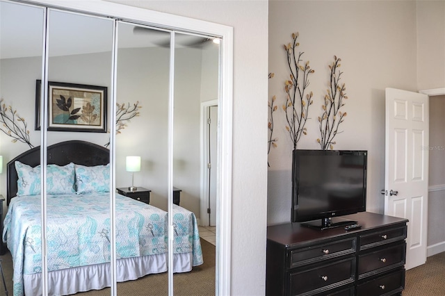 carpeted bedroom featuring vaulted ceiling and a closet