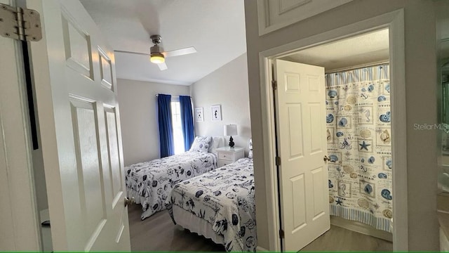 bedroom with dark hardwood / wood-style floors and ceiling fan