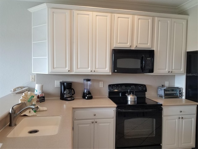 kitchen featuring white cabinetry, sink, and black appliances