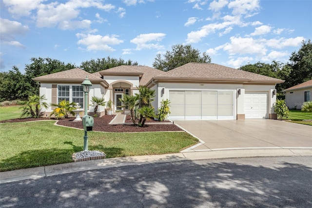 view of front of property with a front yard and a garage