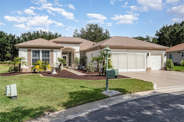 view of front of home featuring a front yard and a garage