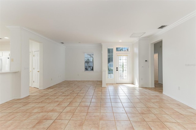 tiled spare room featuring crown molding