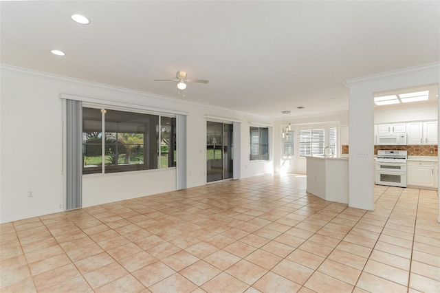 unfurnished living room with ceiling fan, light tile patterned floors, sink, and ornamental molding