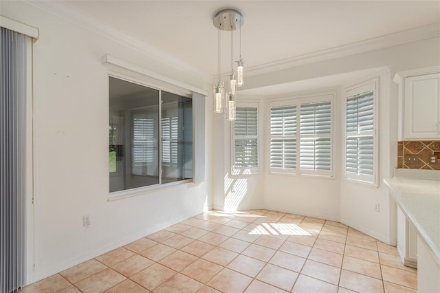 unfurnished dining area with light tile patterned floors and crown molding