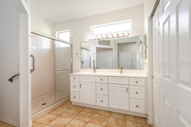 bathroom featuring an enclosed shower, vanity, and tile patterned flooring