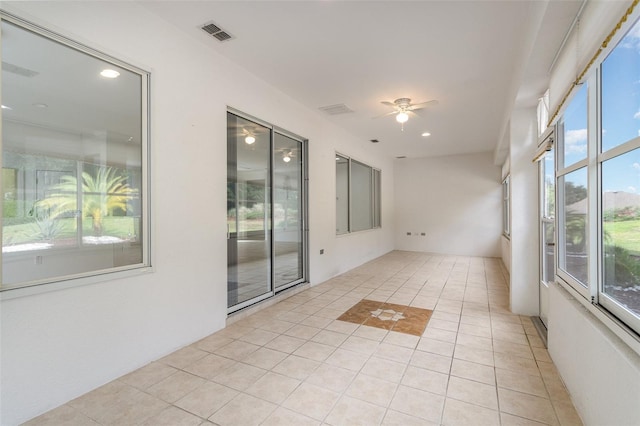 unfurnished room featuring ceiling fan and light tile patterned floors