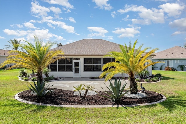 rear view of house featuring a yard and a patio