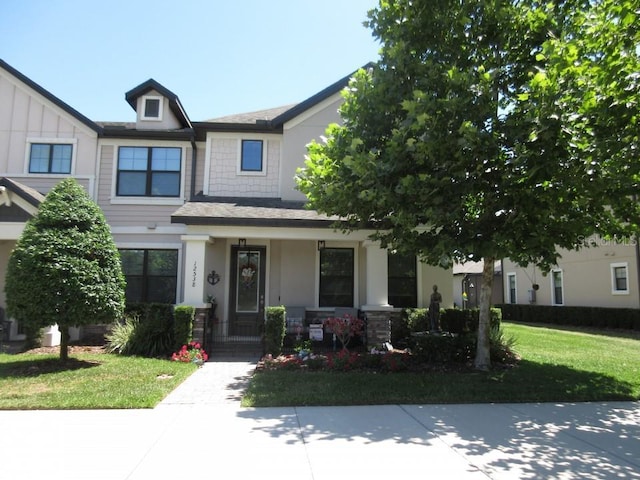 view of front facade featuring a front yard and a porch