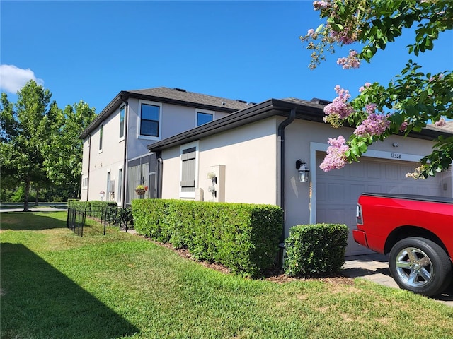 view of home's exterior featuring a garage and a lawn