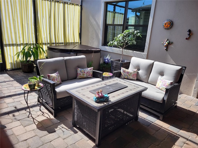 view of patio / terrace with an outdoor living space and a hot tub